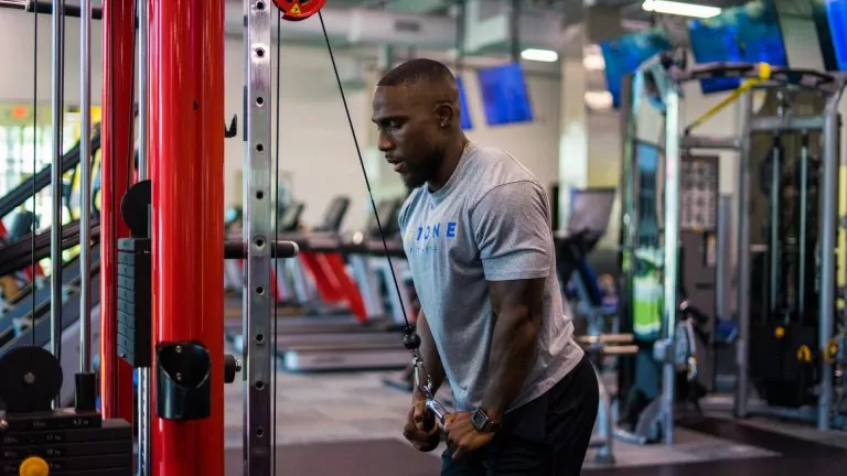 Man In Gray Shirt Working Out at HiTONE Fitness Gym