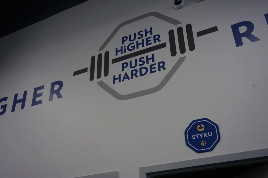 Push harder, push higher sign on a wall.