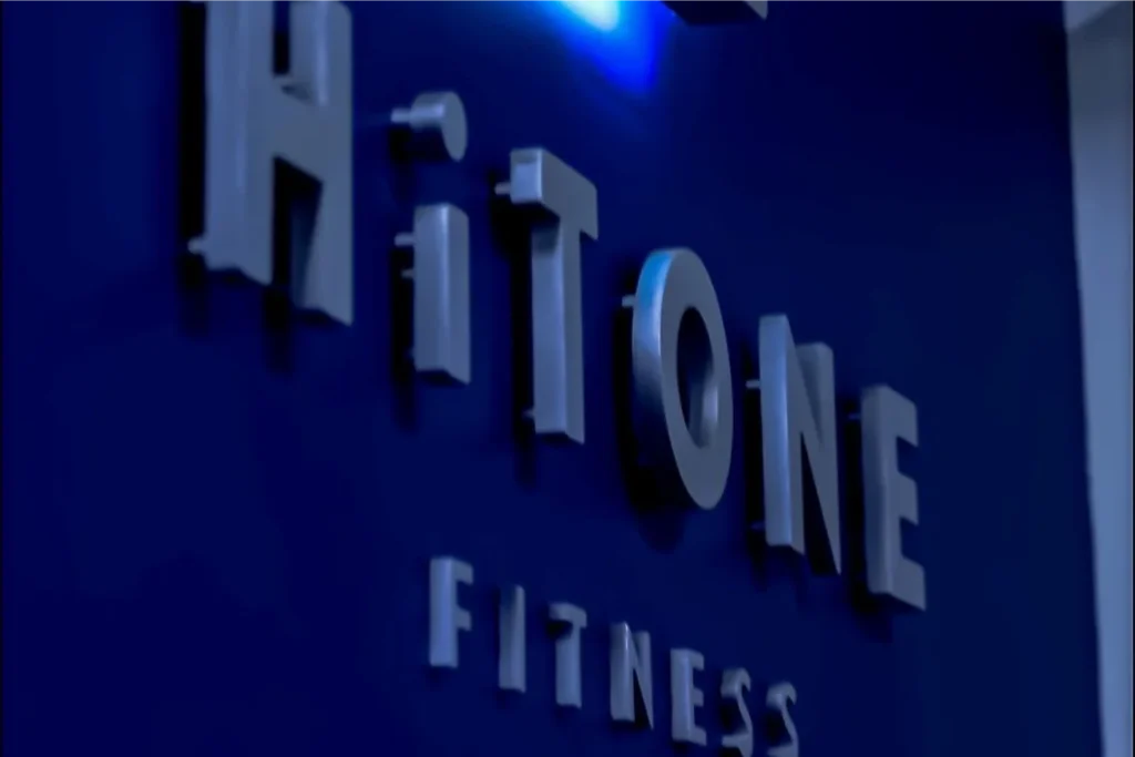Hitone Fitness Logo on a blue wall.