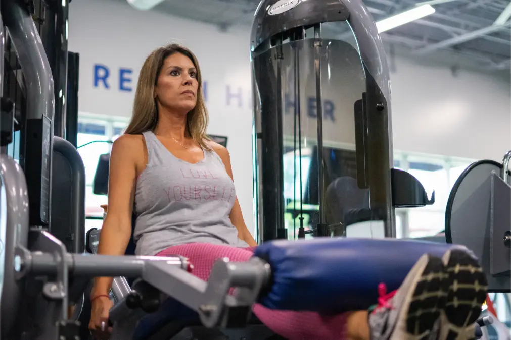 Blonde woman working out her legs.