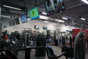 Gym equipment. There are screens above them.