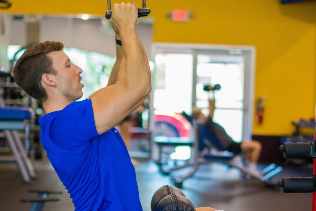 Trainer from Hitone Fitness working out. He has a blue shirt.