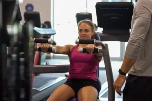 Girl in purple shirt, working out.