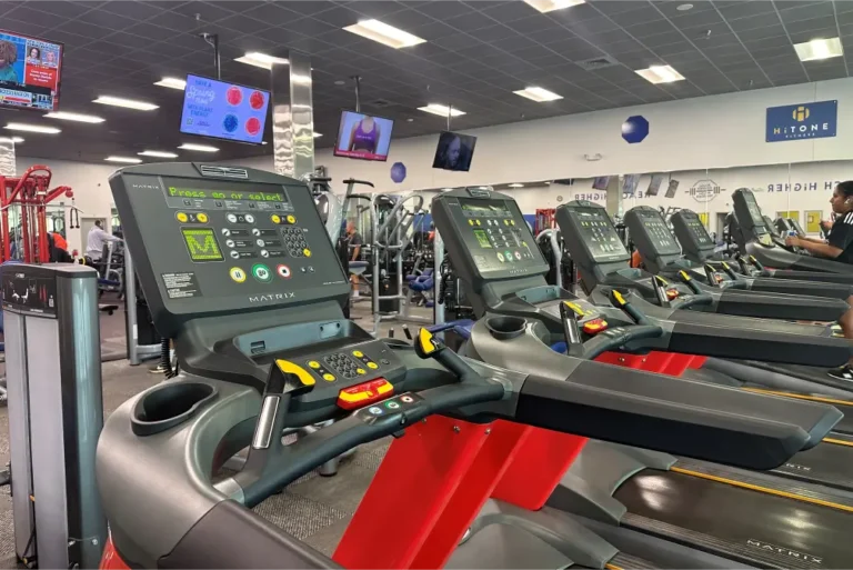 Treadmills at a gym – the screen of one of the machine is prominently shown.