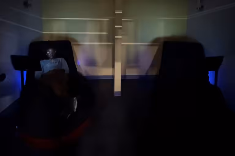 A woman sitting at a hydromassage machine.
