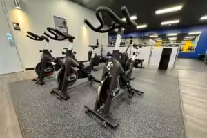 Three exercise bicycles at a gym.