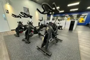 Three exercise bicycles at a gym.