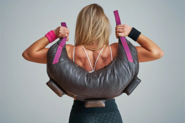 Woman lifting Bulgarian bag over shoulders from behind