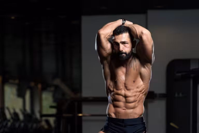 Muscular man exercising in gym.