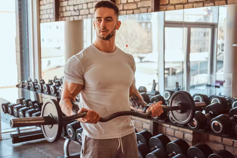 Man lifting weights in gym environment