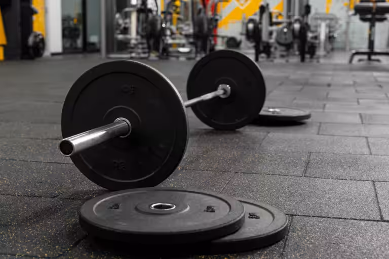 Barbell with weight plates on gym floor