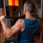 Man performing lat pulldown exercise at gym machine